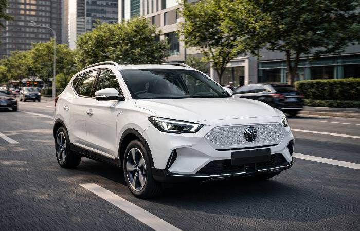 MG ZS EV driving in city traffic highlighting real world electric range conditions