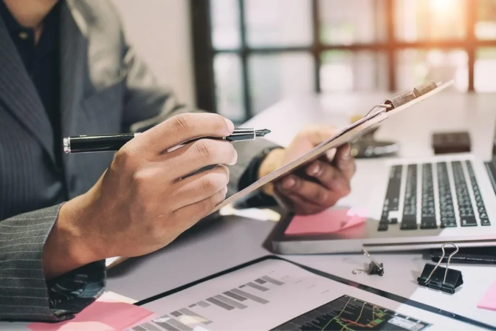 What a High-Quality Mortgage Audit Report Actually Includes Mortgage audit checklist review with loan documents and laptop