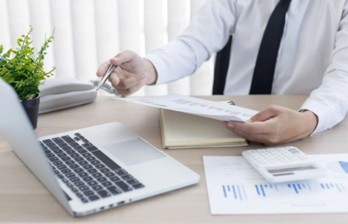 Professional reviewing a mortgage audit report and loan documents Select 84 more words to run Humanizer.