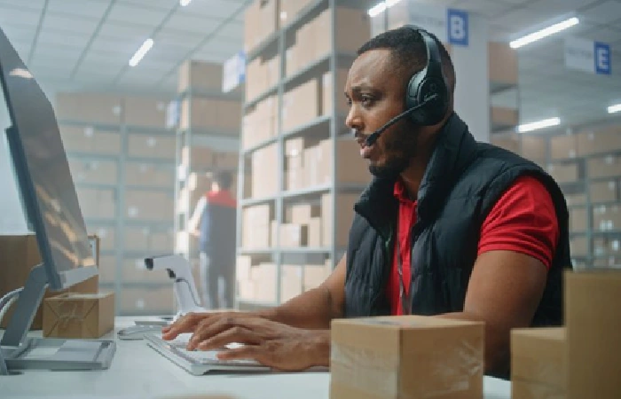 Warehouse customer service agent processing orders at a fulfillment center